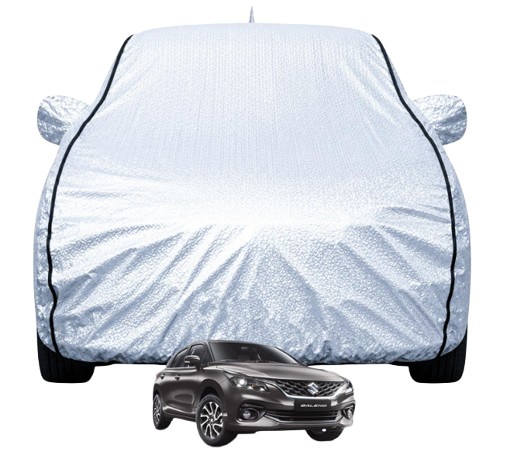 (FABTEC Car Body Cover): Metallic silver waterproof car body cover with custom mirror pockets and black piping contours installed on a Maruti Suzuki Baleno parked outdoors.