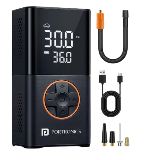 Compact black portable cordless tire inflator with a large digital display readout and built-in LED flashlight positioned next to a large SUV tire on an unpaved road.
