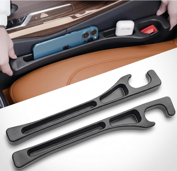 Dual black PU leather car seat gap organizer inserts featuring open storage pockets for smartphones and charging cables, installed securely between front car seats and center console.