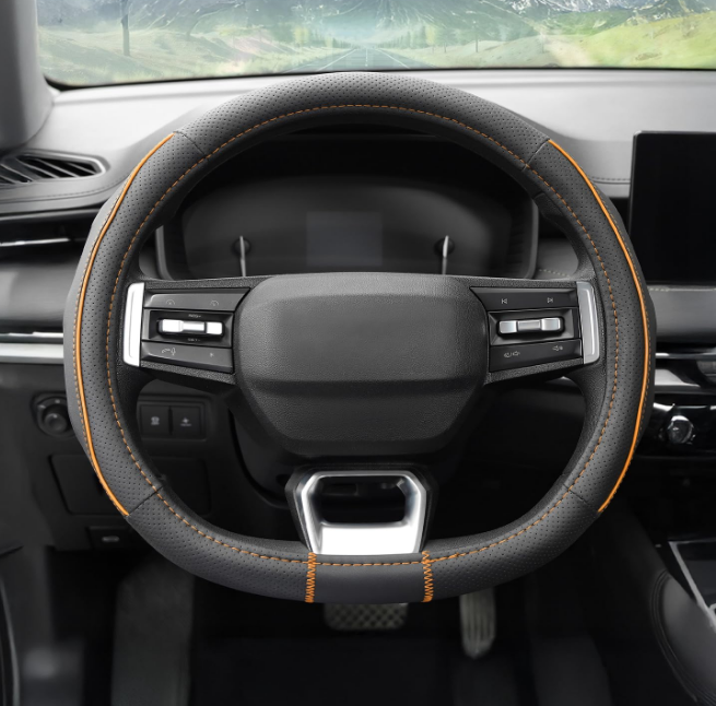 Amazon Basics black and orange perforated leatherette steering wheel cover with sporty contrast stitching and durable rubberized backing.