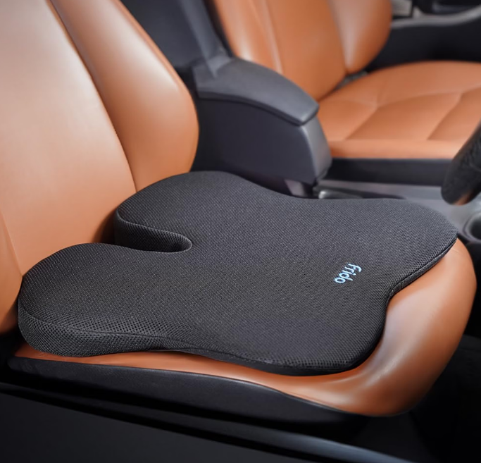 Frido black memory foam car wedge seat cushion with coccyx cutout placed on driver seat